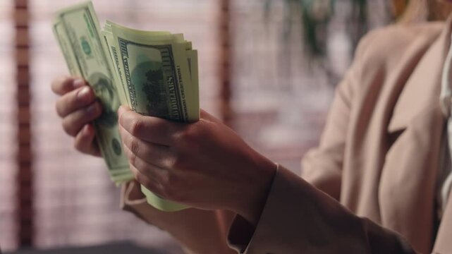 Close up unrecognizable Caucasian business woman female girl businesswoman office worker saleswoman accountant hold stack dollars money counting salary income prize bonus finance cash payment indoors