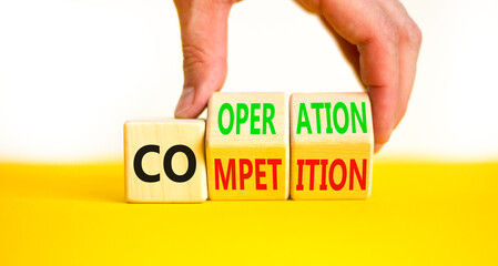 Competition or cooperation symbol. Concept word Competition or Cooperation on wooden cubes. Businessman hand. Beautiful white background. Business Competition or cooperation concept. Copy space.