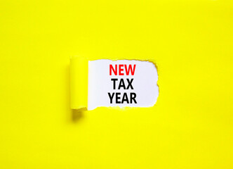 New tax year symbol. Concept words New tax year on beautiful white paper. Beautiful yellow table yellow background. Business new tax year concept. Copy space.