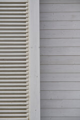 Close-up of a white wooden slatted wall and paneling