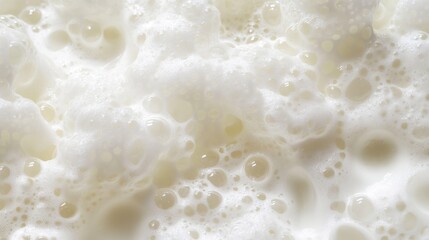 White foam background showcasing a variety of bubble sizes in a clean, abstract design. 