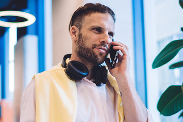 Handsome Caucasian businessman making cellphone consultancy conversation for discussing mobility...