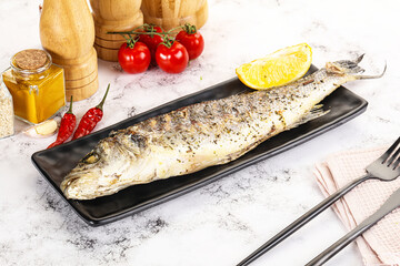 Grilled sea bass fish served lemon