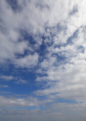sky and white clouds in vertical ideal as a background for nature, purity, or weather forecasts