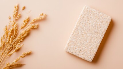 A simple soap bar rests beside tufts of dry grass, showcasing a natural and rustic setting that emphasizes organic beauty and everyday essentials.
