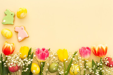 Spring Easter background, multi-colored Easter eggs with tulips and gypsophila and decorative...
