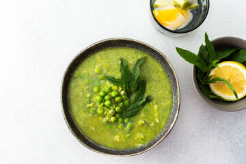 Creamy broccoli and green pea soup with mint, delicious healthy lunch