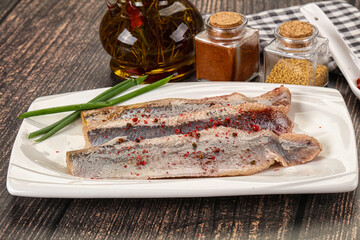 Salted marinated herring fillet with spices