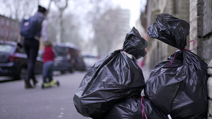 Trash at side road in city for pick-up. Pollution black garbage trash