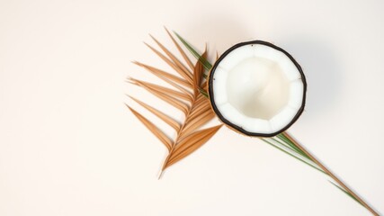 Fototapeta premium Tropical Coconut Half with Dried Palm Leaf on White Background