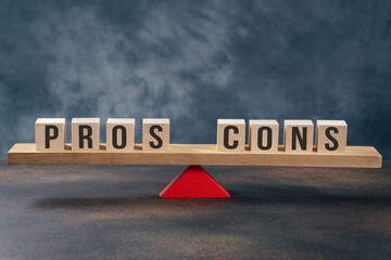 Seesaw with text pros and cons on gray background