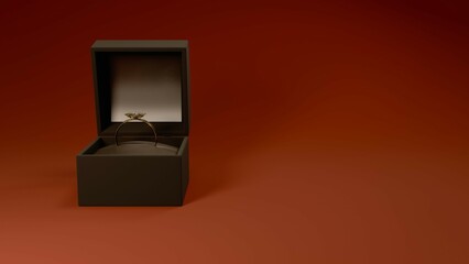 Gold engagement ring in open black jewelry box on red background.