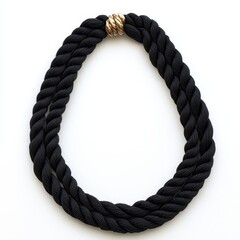 A detailed close-up showcasing a black rope necklace featuring an elegant gold clasp, highlighting its craftsmanship and design.