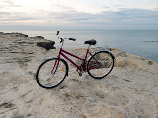 Fototapeta premium Bicycle on the rocky coast of the sea.