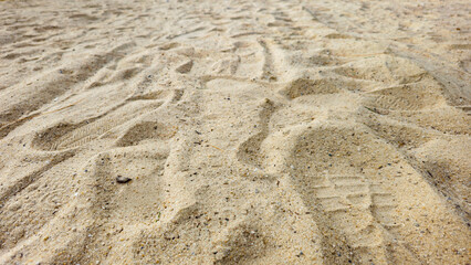 Closeup Shoe Print on the Sand at the Beach, mark left by a shoe on the surface of the sand. 