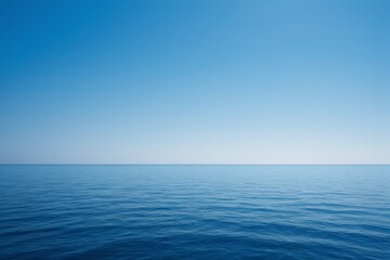 arafed view of a calm ocean with a clear blue sky