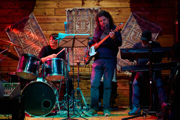 Heavy metal band performing at a lively concert venue late at night