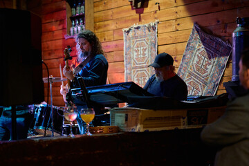 Heavy metal band performs at vibrant venue with energetic crowd and dynamic atmosphere