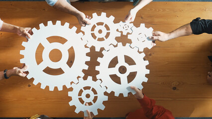 Top view of business people gathering white gear together at meeting table. Group start up team in...