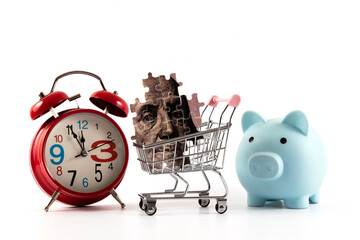 Puzzle portrait of Benjamin Franklin with $100 bill in miniature supermarket shopping cart on white background