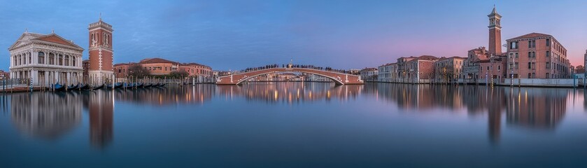 Fototapeta premium Calm Venetian canal dawn, bridge reflection, historic buildings. Travel postcard