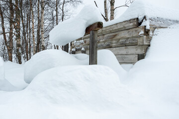 A massive pile of snow in front of a building, almost covering the windows. The scene highlights...