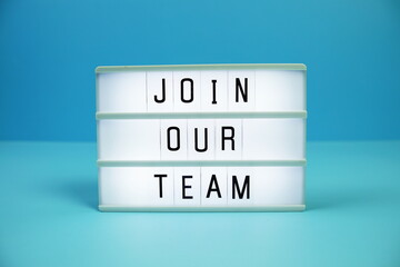 Join Our Team letterboard text on LED Lightbox on blue background