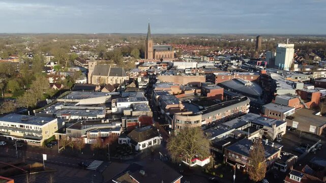 Raalte, the Netherlands - January 10th 2025: Aerial footage of the town center. Drone flies slowly over the 'grotestraat' towards the Basilica. 