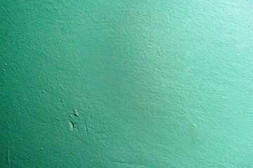 A close-up of a green textured surface with minor imperfections and subtle variations in tone. The matte finish and uniformity make it ideal for abstract design projects or as a background 