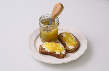 Enjoy a delicious toast topped with homemade fruit jam served on a pristine white plate.