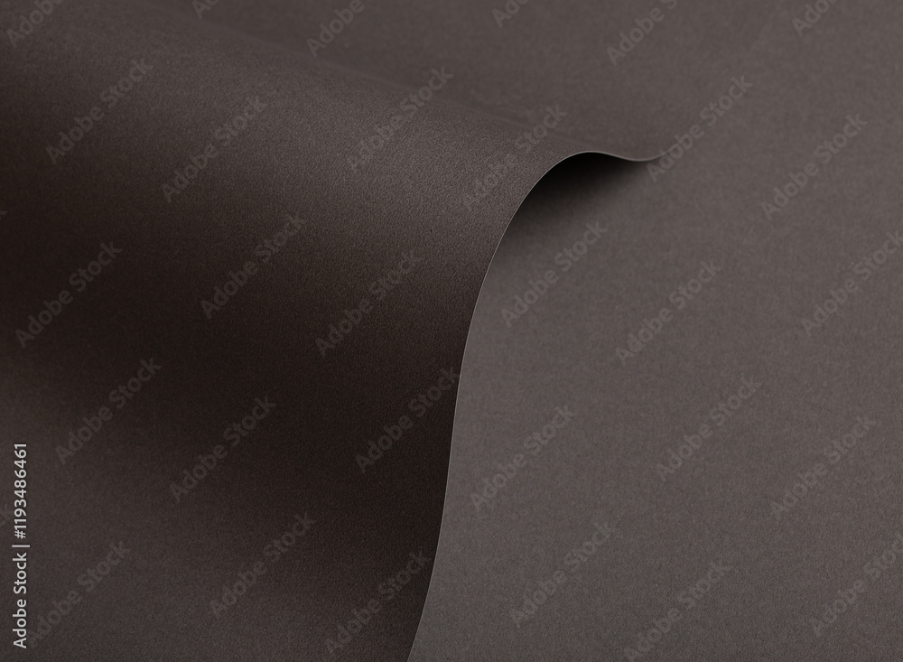 Poster charcoal gray paper background with curved, matte surfaces and a smooth, reflective texture. dark mo