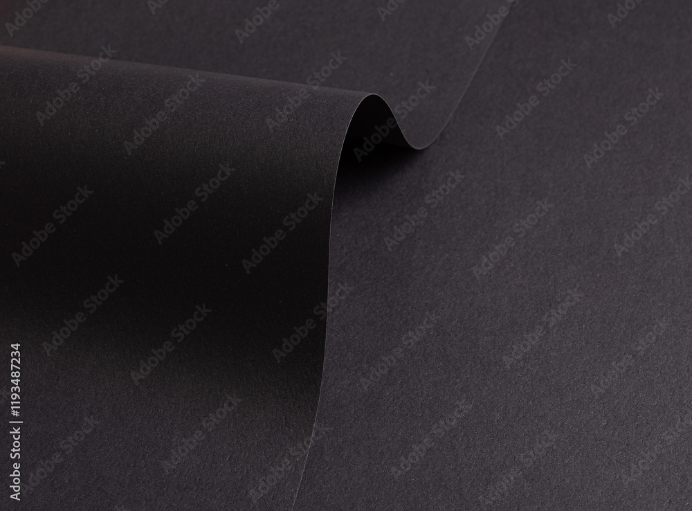 Poster charcoal gray paper background with folded, curved matte surfaces. smooth and minimalistic, the desi