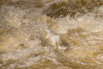 Close up of splashing and foaming water in river rapids.