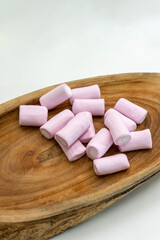 Wooden tray with pink marshmallows, perfect for cozy, sweet moments and food-related themes. Ideal for dessert, party, and confectionery photography.