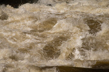 Close up of splashing and foaming water in river rapids.