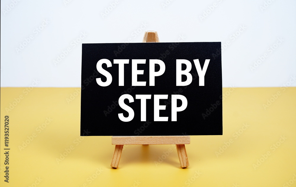 Poster step by step text written on paper card with easel standing on yellow background