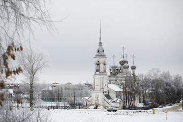 Snowy Winter Scene of a Russian Orthodox Church with Frost-Covered Trees and Overcast Sky