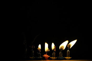 Seven Burning Candles on a Dark Background Emitting Warm Light and Celebrating Special Occasion