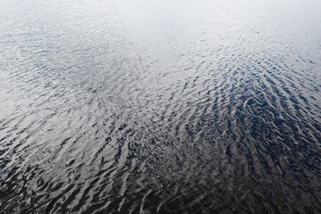 Tranquil Rippling Water Surface Reflecting Light in Calm Natural Setting