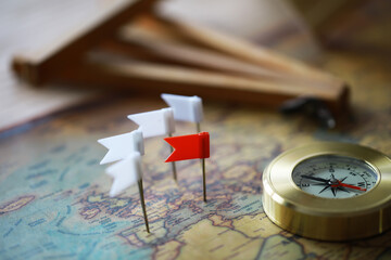 Navigation Compass and Flag Pins on Vintage World Map