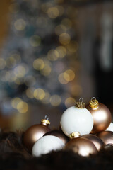 Festive Christmas Ornament Arrangement with Golden and White Baubles Against Twinkling Lights