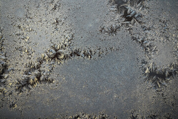 Frost Patterns on Window Glass Captured in Winter Morning Light