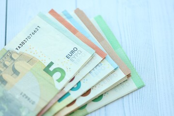 Big amount of different denominations of euro money bills on wooden background