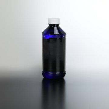 Liquid cosmetic bottle with blank label for product presentation. Blue container with black label mock-up.