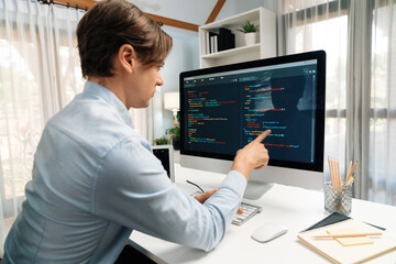 IT developer selecting by point on coding online software development information on pc comparing...