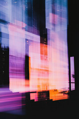 Obraz premium Vibrant Abstract Urban Nightscape with Illuminated Modern Architecture and Reflective Skyscraper Patterns