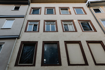 Fototapeta premium Abandoned building with multiple windows and an unsettling atmosphere in a quiet urban area