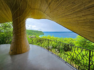 a wellness shala overlooking the blue waters of Culebra Bay, lush green trees, blue sky and clouds in Liberia Guanacaste Costa Rica