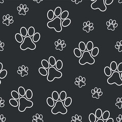 Fototapeta premium Paw Pet Footprint Pattern - White Contour of Pet Footprint on Black Background. Seamless Link.