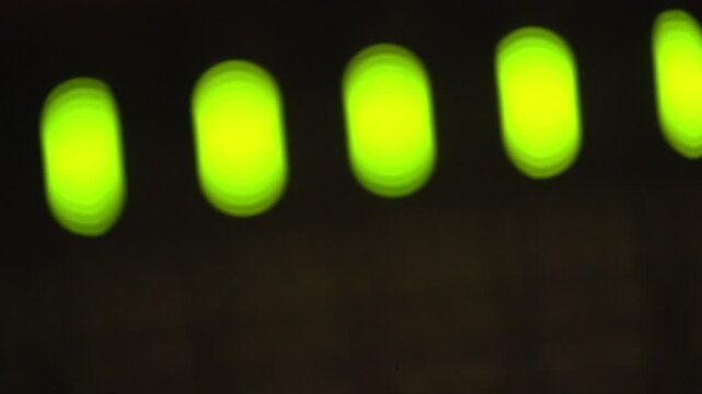 Bokeh lights of closeup of a solid-state logic in a recording studio